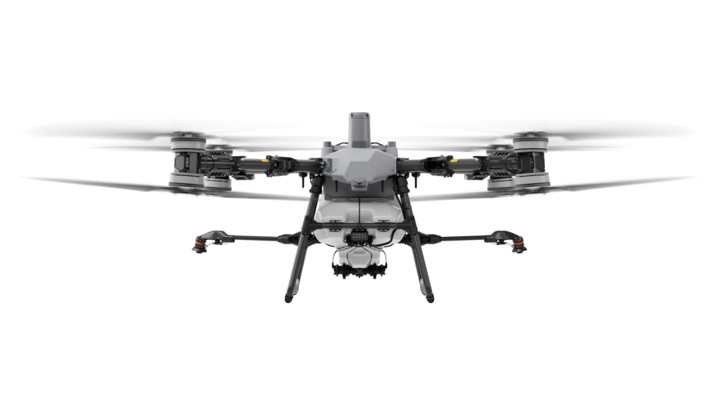 DJI Agras T100 agricultural spray drone in flight over a Texas field